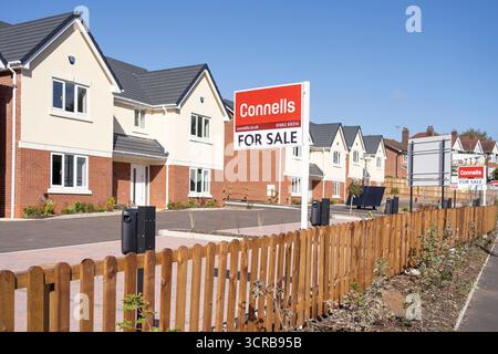 A row of new built homes on sale with Connells estate agent. All houses have electrical charging points for electric cars. Stock Photo