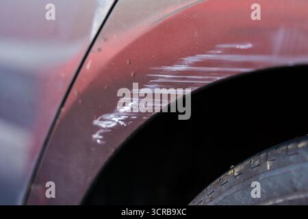 Scuff marks on the wheel arch of a grey hire car Stock Photo