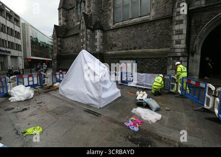 Dublin, Ireland  -  18th July 2014 - Workers in hard hats at near a covered up Molly Malone Statue on Saint Andrew's Street in Dublin city centre depicting street life in the Irish capital Stock Photo