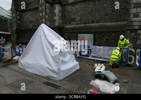 Dublin, Ireland  -  18th July 2014 - Workers in hard hats at near a covered up Molly Malone Statue on Saint Andrew's Street in Dublin city centre depicting street life in the Irish capital Stock Photo