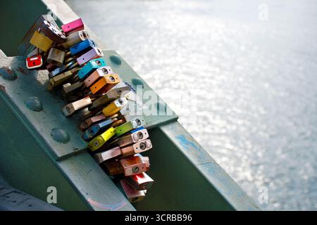 Colorfull locks of couples in love on the bridge in Frankfurt, Germany Stock Photo