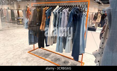Clothes on hangers in a clothing store Stock Photo