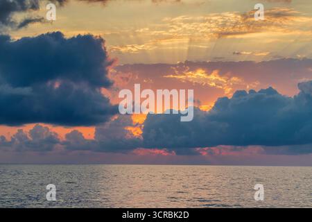Shot of the dramatic sunset by the beach. Stock Photo