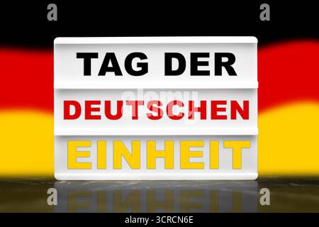 Bavaria, Germany - September 30, 2025: PHOTOMONTAGE, German Unity Day holiday in Germany. Lightbox with Germany flag or flag with the inscription: Day of German Unity in national colors *** FOTOMONTAGE, Tag der Deutschen Einheit Feiertag in Deutschland. Lightbox mit Deutschland Flagge bzw. Fahne mit der Aufschrift: Tag der Deutschen Einheit in Nationalfarben Stock Photo