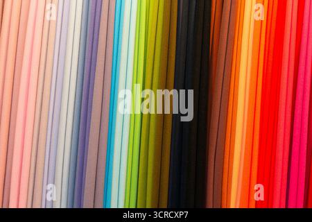 Multicolored textile material in a row on the store counter. Sale Stock Photo