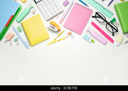 Composition with notebooks, eyeglasses and different school stationery on white background Stock Photo