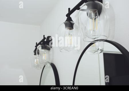 A view of retro light fixtures in a bathroom setting. Stock Photo