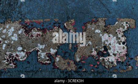 Close-up texture heavily weathered and distressed surface cement or concrete. Dark, muted teal or slate blue paint that is severely chipped, peeling, Stock Photo
