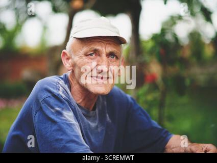 Senior man with gray hair 60-65 year old over nature background close up. Mature lifestyle. Stock Photo