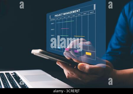 Project manager is working on virtual screen, using project management system. Gantt chart interface to plan tasks, schedule milestones, track progres Stock Photo