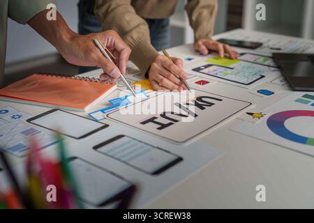 UX UI Design Collaboration. Creative team brainstorming on mobile app interface. Stock Photo