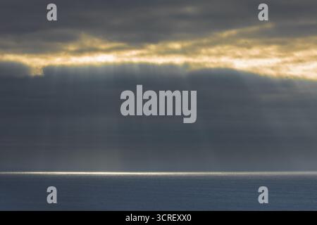 Sunbeams streaming through fog opening in the Pacific Ocean at Big Sur, California. Stock Photo