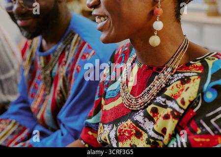 Young Black Man and Woman Smiling and Celebrating Kwanzaa Together Indoors Stock Photo