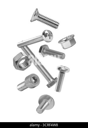 Different bolts and nuts falling against white background Stock Photo