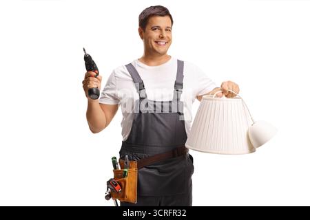 Worker holding a lampshade and a power screwdriver isolated on white background Stock Photo