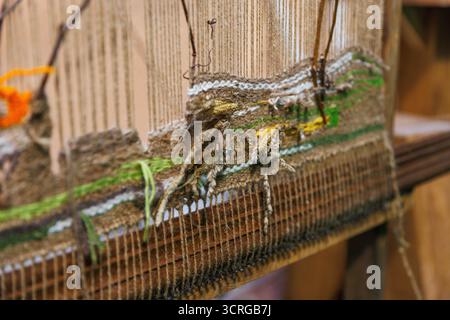 This image showcases a detailed woven tapestry featuring various textures and colors, emphasizing the natural materials used, reflecting a blend of cr Stock Photo