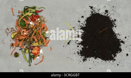 Bio-waste turning into compost. View from above with yellow arrow drawn with chalk. Stock Photo