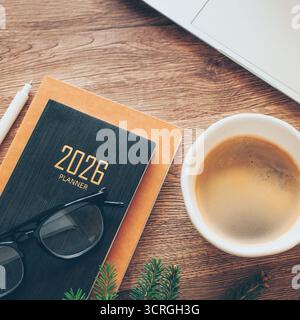 Stylish Desk Setup With 2026 Planner, Notebook, Pencil, Glasses and Cop of Coffee on Wooden Surface Stock Photo