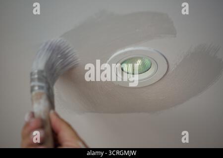 Cutting in. What decorators call the initial painting around objects and edges before applying paint by a roller or spray. Stock Photo