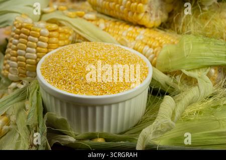Corn Grits in Ceramic Bowl and Fresh Sweet Corn. Stock Photo