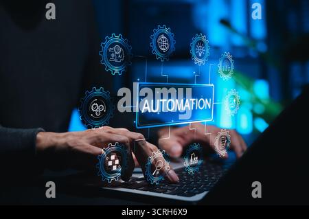 Automation concept in technology and business. Person using laptop while gear icons symbolizing AI, workflow automation, data analysis, cloud Stock Photo