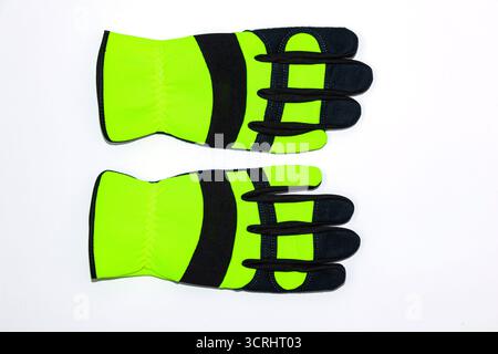 Protective work gloves on a white background, green - black with black leather and green synthetic material. Stock Photo