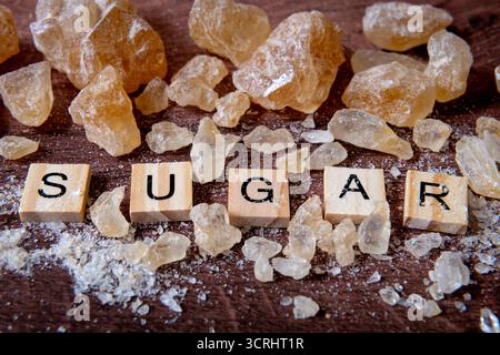 A close up of the word sugar surround by rock sugar in various size and shapes. Stock Photo