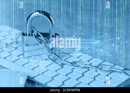 Padlock and chain on computer keyboard, toned in blue. Circuit board pattern and binary code. Cyber security Stock Photo