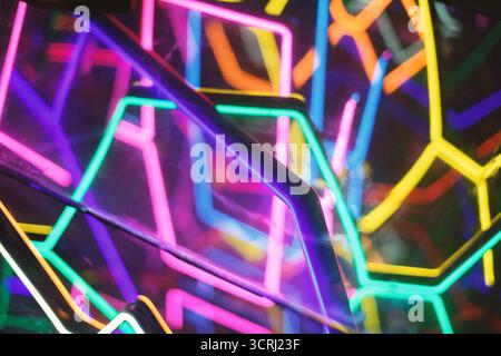 A photo featuring a background of colorful tangled neon lights, creating a mesmerizing and dynamic urban night scene with vivid hues and glow Stock Photo