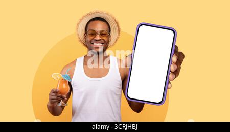 Enjoying a Refreshing Drink While Showcasing a Smartphone in a Bright and Cheerful Setting Stock Photo