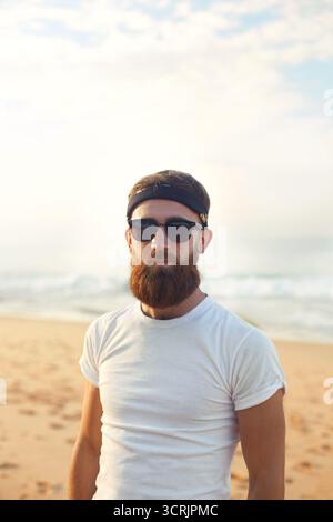 Portrait of handsome bearded man in shirt on the beach Stock Photo