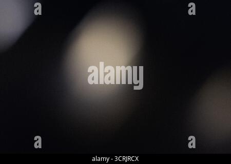 Vintage soft light leak overlay effect with film grain texture, retro blurred glow on dark background, cinematic atmosphere Stock Photo