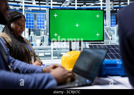 Factory manager meeting with investors, using isolated screen monitor to showcase manufacturing strategies. Man using mockup display to show shareholders report of production growth opportunities Stock Photo