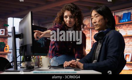 Coworkers collaborating in AI tech agency providing software development services. Teamworking startup office colleagues using artificial intelligence to streamline coding process, camera B Stock Photo