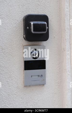 Doorbell installed on a white wall for home access Stock Photo