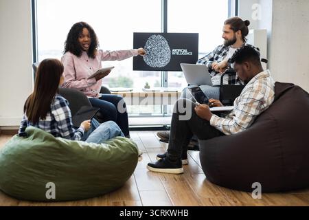 Team collaborating on artificial intelligence project in office Stock Photo