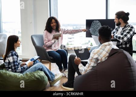 Team collaborating on artificial intelligence project in office Stock Photo