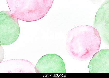 Abstract watercolor artwork with pink and green circular shapes on white background. Stock Photo