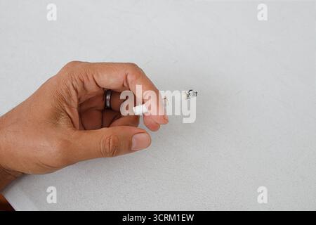 Lighting cigarette in ashtray isolated on white background Stock Photo