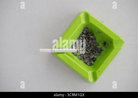 Lighting cigarette in ashtray isolated on white background Stock Photo