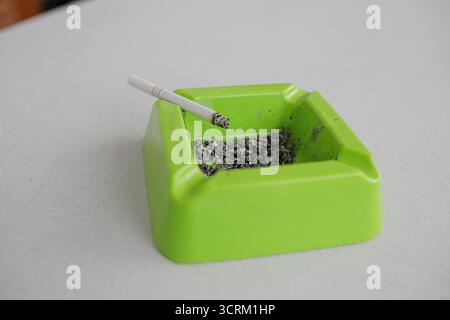 Lighting cigarette in ashtray isolated on white background Stock Photo