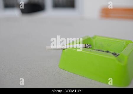 Lighting cigarette in ashtray isolated on white background Stock Photo
