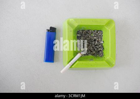 Lighting cigarette in ashtray isolated on white background Stock Photo