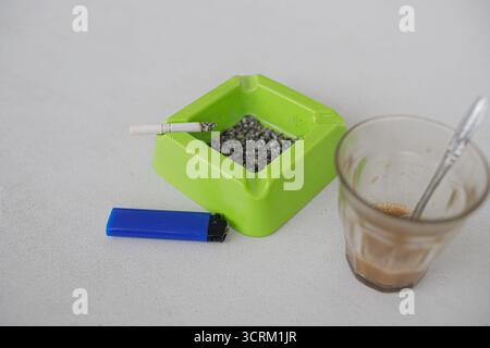 Lighting cigarette in ashtray isolated on white background Stock Photo
