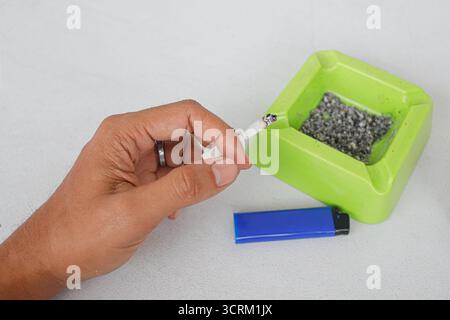 Lighting cigarette in ashtray isolated on white background Stock Photo
