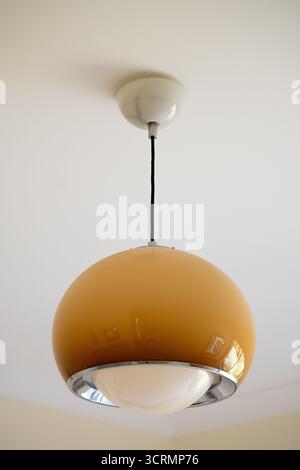 Old hanging light fitting, Dome shaped, beige and white plastic. Original from Habitat store, UK, early 1970s. Classic 70's shape. In continuous use. Stock Photo