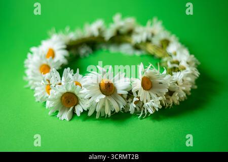 Daisy wreath on green background. Summer concept Stock Photo