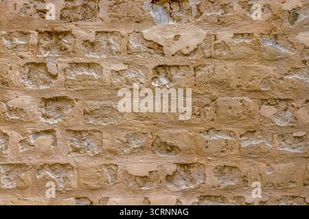 The unique texture of a section of the weathered adobe wall of a farm house, in the eastern Andean mountains of central Colombia Stock Photo