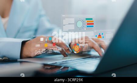 Close-up of businesswoman working on laptop with digital data analytics dashboard, business report charts, and visualization technology for financial Stock Photo