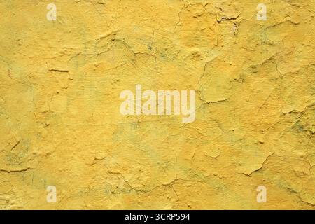 Old yellow grunge wall with cracked paint. High resolution vintage background. Stock Photo
